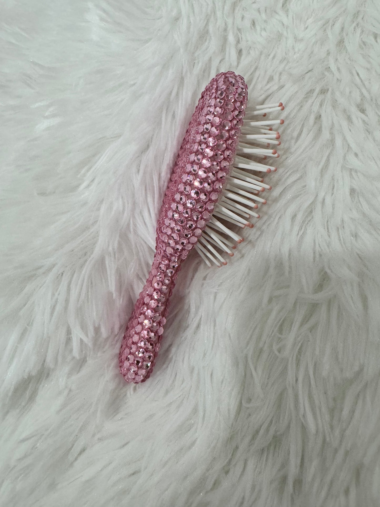 Light pink hair brush